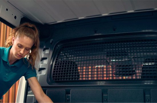 A woman in the rear of a van with a partition