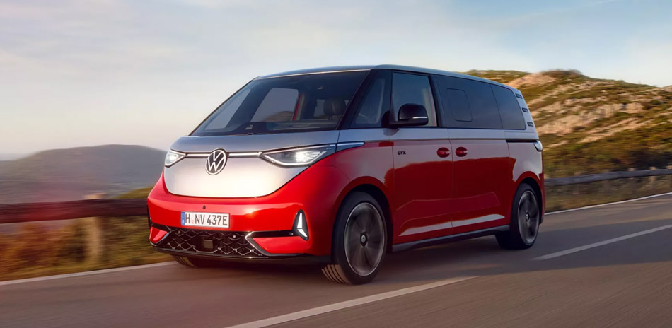 Red and Silver electric van driving on a road at sunset