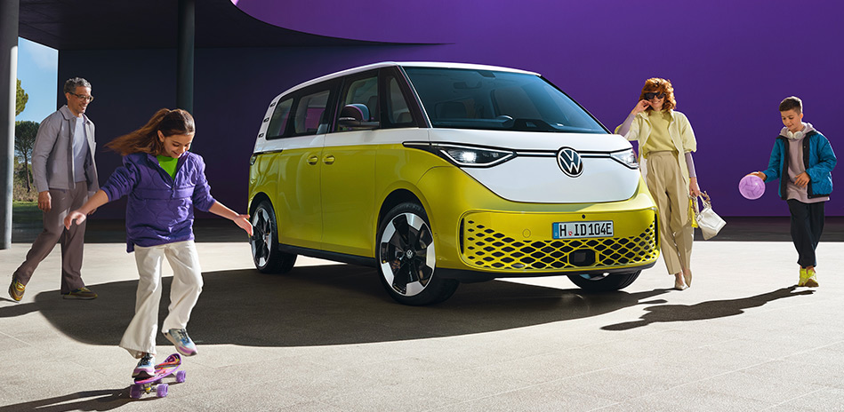 A family around a yellow & white Volkswagen electric van