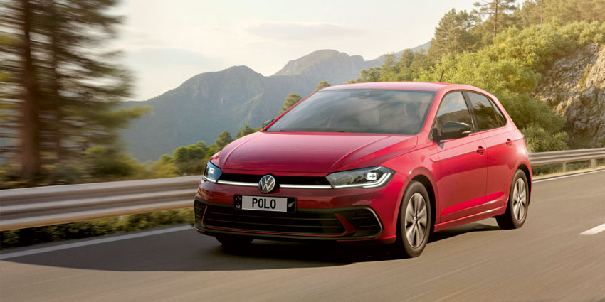 Red VW polo driving on a mountain road