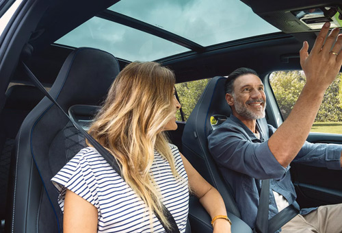 A couple sitting in the front seats of a Tayron SUV