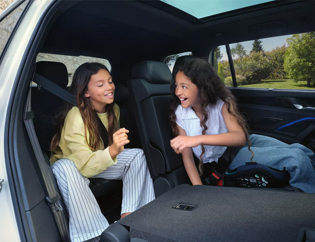 Two girls in the rear second and third row of seats in a Tayron SUV