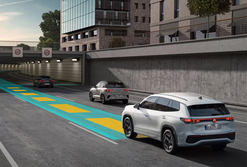 Image of a Tayron driving with graphics showing travel assist