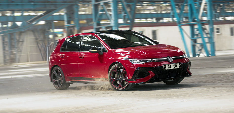 A Red Golf GTI driving in an empty warehouse