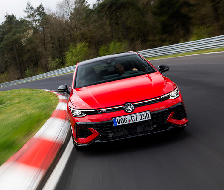 Front of a red Golf GTI driving on a race track