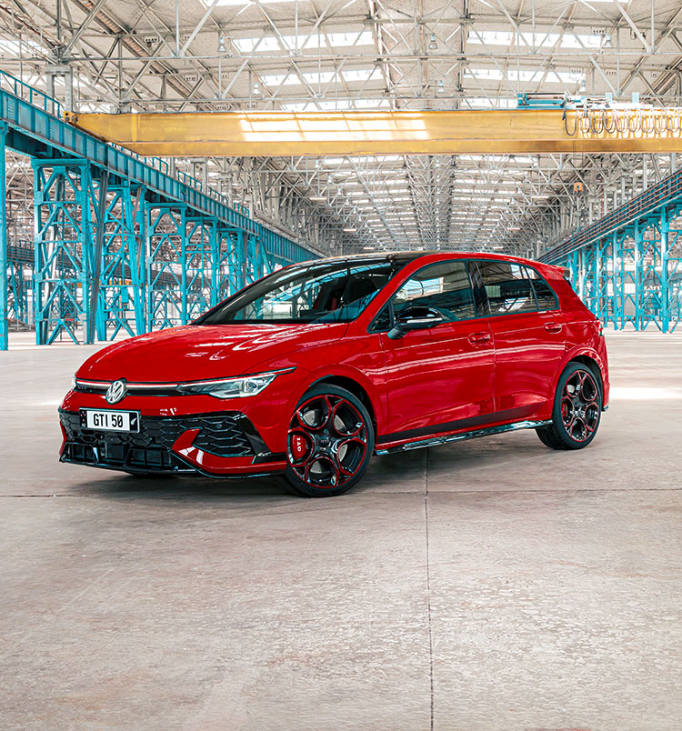 A red Golf GTI parked in an emtpy warehouse